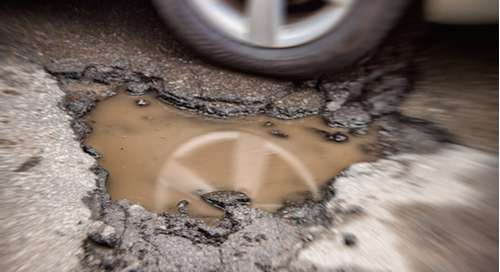 car wheel avoiding a pothole