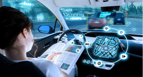 Woman reading book in self-driving car