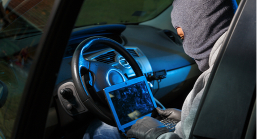 Hacker in a car at a computer